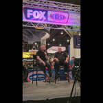 Bruce Bennett from Stage 8 Locking Fasteners on the stage with Brian Lohnes and NHRA TV